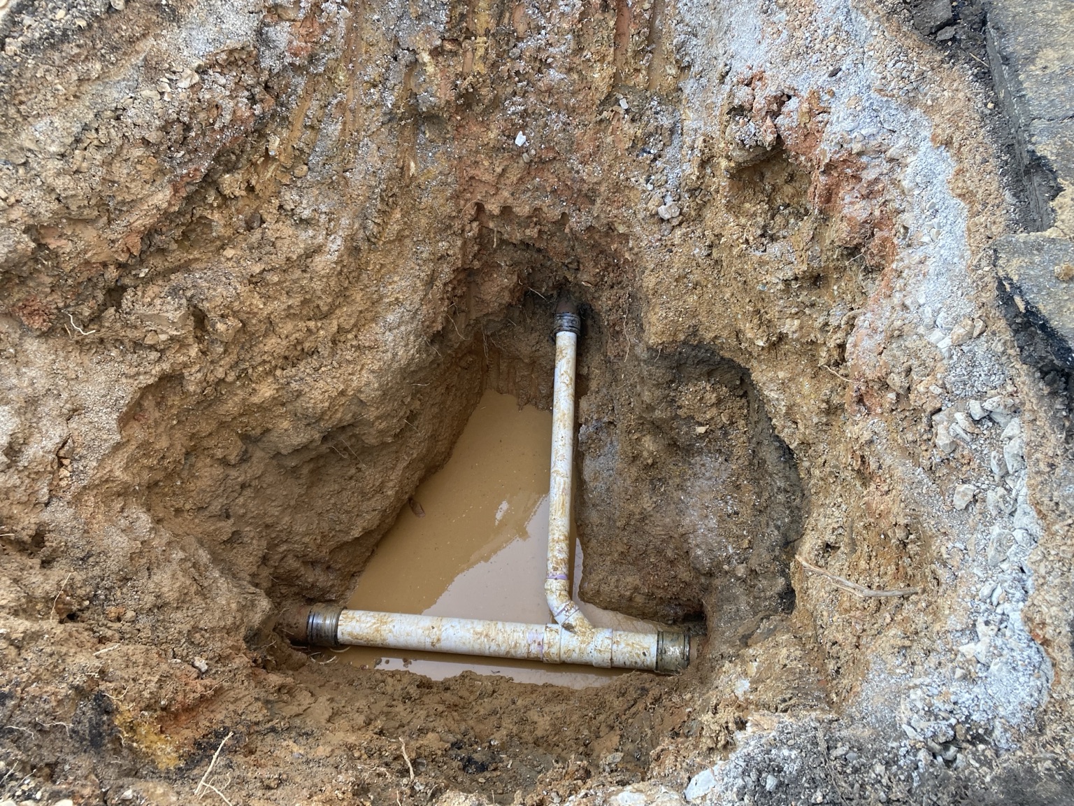Excavated sewer line repair in progress